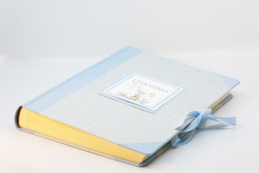 Album personalizzato 23x30 bimbo, copertina in carta a righine azzurre e tela azzurra con cartellino Giacomo e nastro di chiusura